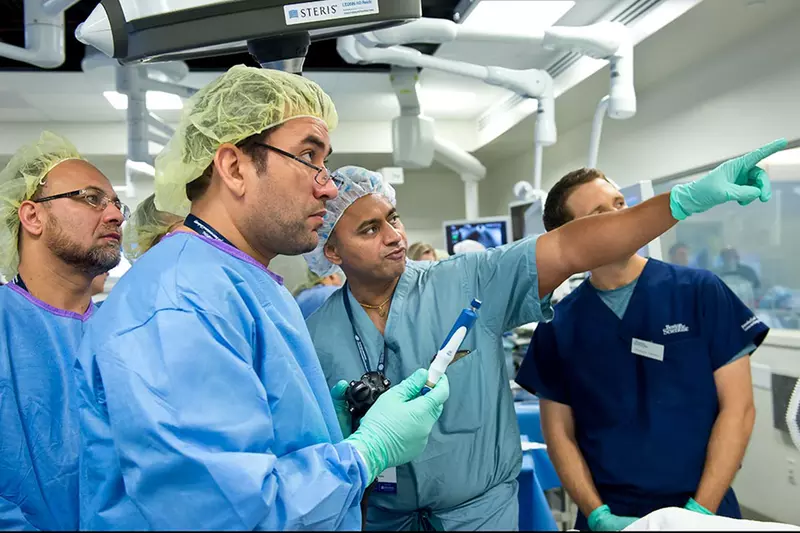 Surgeon receiving instruction in a Nicholson Center operating room.