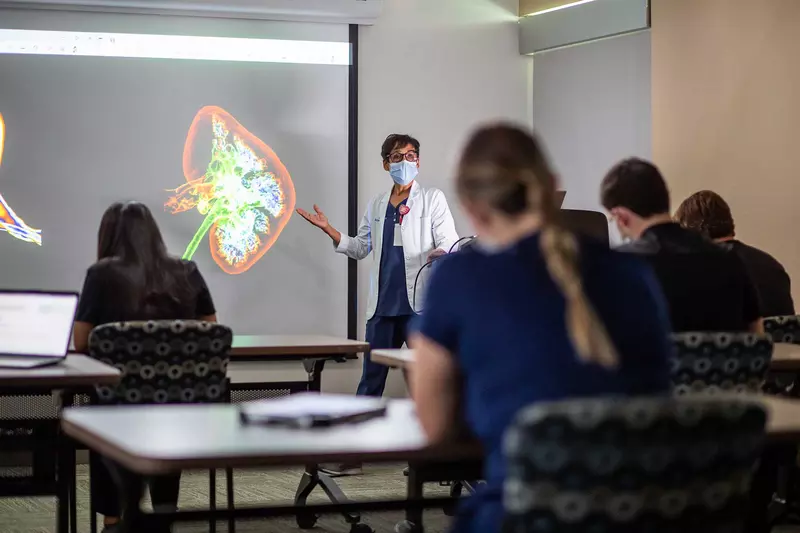 An AdventHealth physician conducting a lecture to her colleagues.