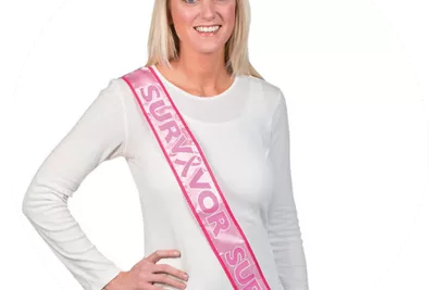 Woman wearing breast cancer survivor sash