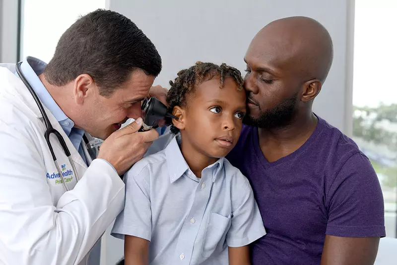 Provider checking child's ear