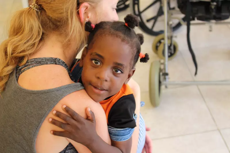 Woman holding a small child.