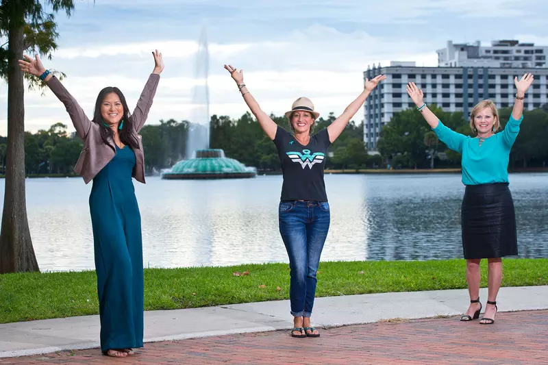 Three female cancer survivors in front of Lake Eola