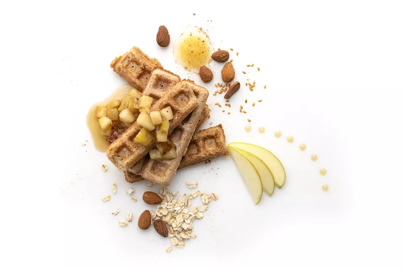 Waffle strips with apple and almond garnishes