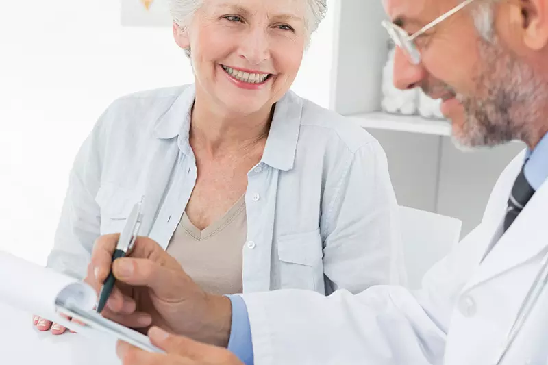 A senior talks with her doctor.