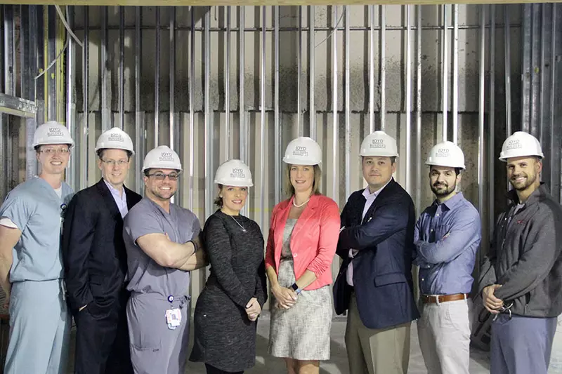 AdventHealth employees posing at a construction site