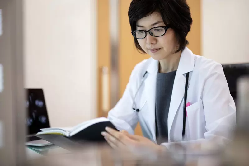 A female doctor reviews materials. 