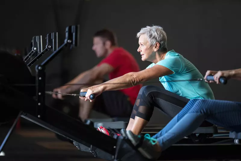 Woman on a rowing machine.