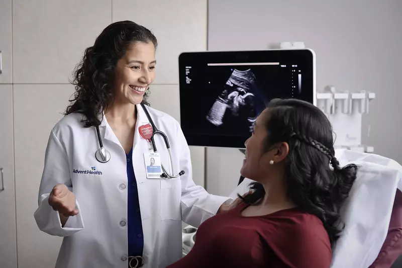 A pregnant woman talking to her doctor about imaging results