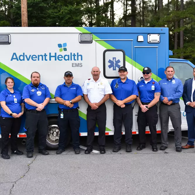 EMS Team stands in front of new ambulance