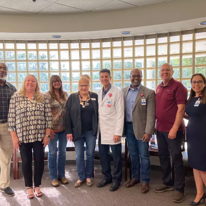 Clinic patients and cancer survivors, Teresa Ledford and Rena Weldon visits with AdventHealth physicians, leaders and State Representative Truenow.  