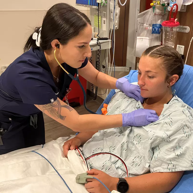 Christina Vega, RN, a recent graduate of the Lake Sumter State Dedicated Education Unit at AdventHealth Waterman treats a patient in the emergency department.