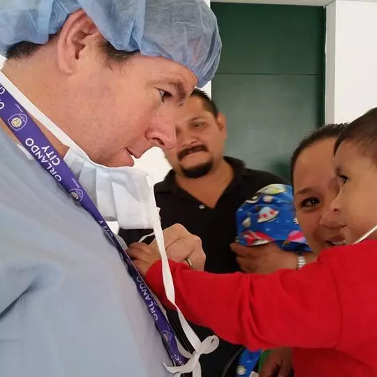 A doctor holds a child