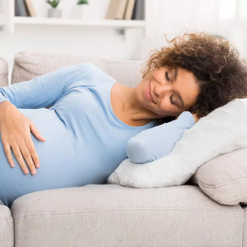 A pregnant woman resting at home.