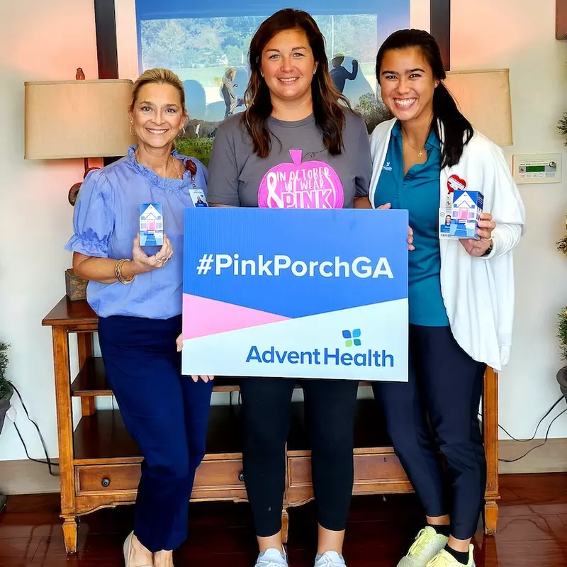 Lacee Landru (middle) holds up the PinkPorchGA sign with Cedartown clinic practice manager Tammy Jarrell and her oncology occupational therapist, Carolyn Perry.