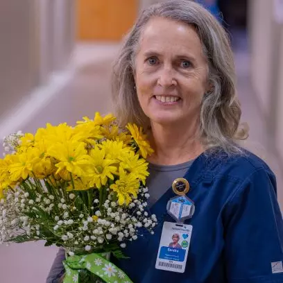 AdventHealth Hendersonville DAISY Award winner offers compassionate  care to a patient in pain.