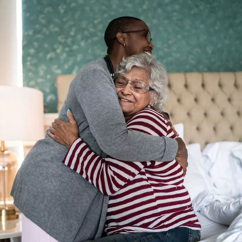 A Nurse Embraces Her Elderly Patient