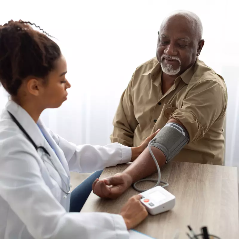 A Doctor Takes a Patient's Blood Pressure with a Blood Pressure Cuff
