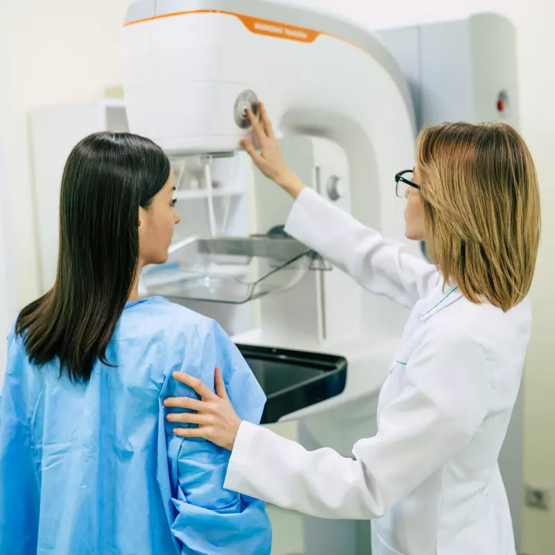 A Provider Prepares a Patient for Her Mammogram.