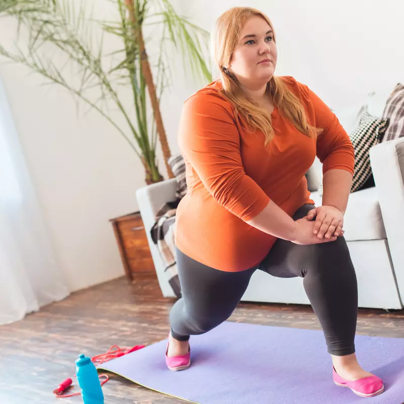 A Woman Stretches During Yoga in Her Home