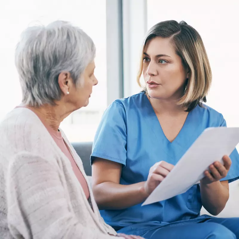 A Physician Goes Over a Chart with a Senior Patient.