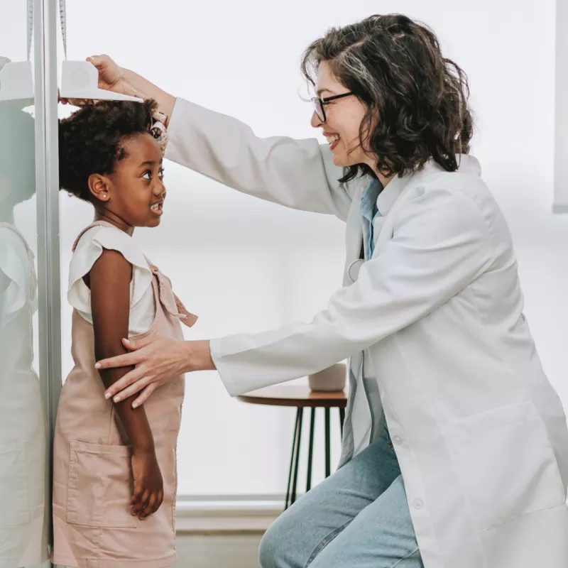 A Physician Checks Her Pediatric Patient's Height