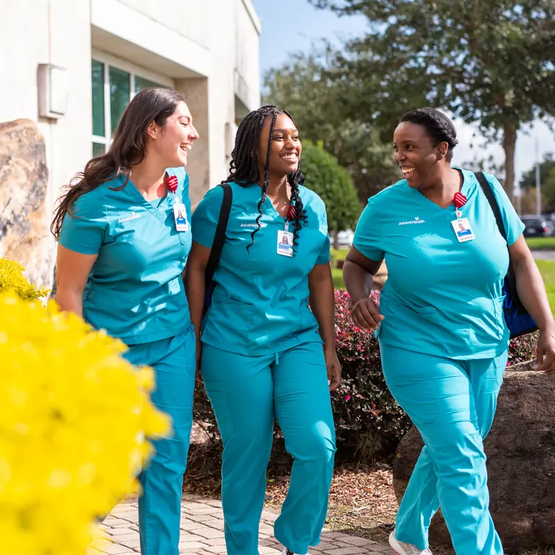 3 nurses walking outside a hospital