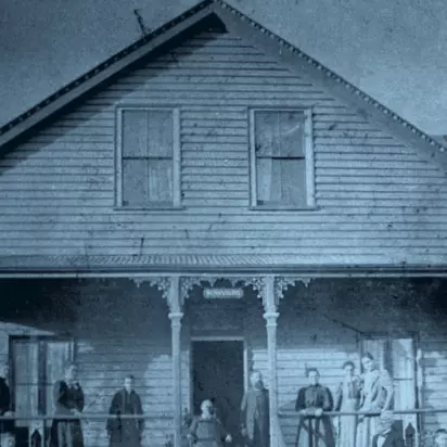 Men and women standing outside of a sanitarium