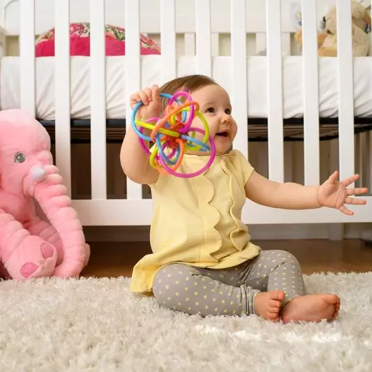 Baby plays with her toy at home