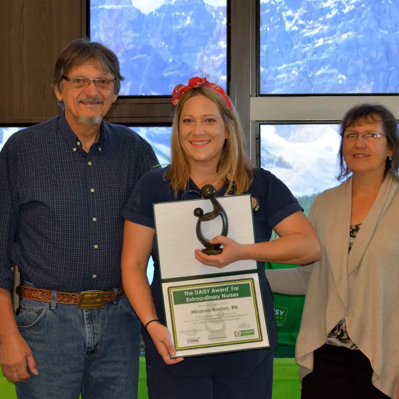 Miranda Boehm, a registered nurse at AdventHealth Fish Memorial, received the DAISY award, an international program that rewards and celebrates extraordinary clinical skill and compassionate care provided by nurses. Pictured here: Boehm (center) stands with her parents Robert and Christine Young. 