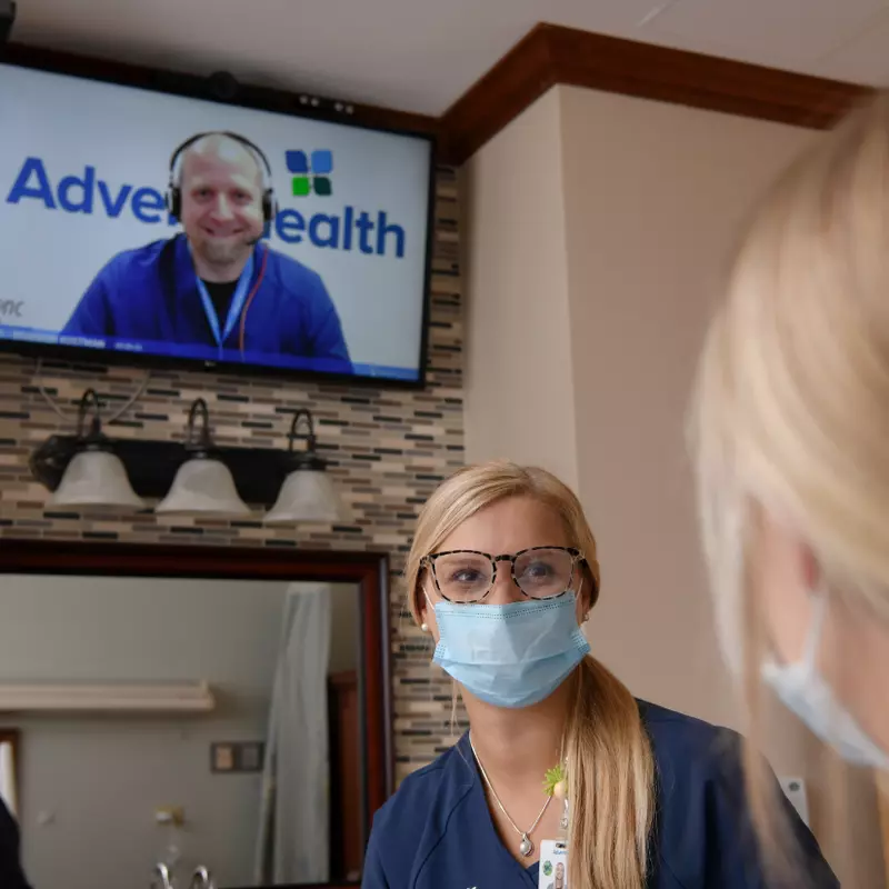 A virtual nurse comes on the television in a patient's room at AdventHealth Deland.