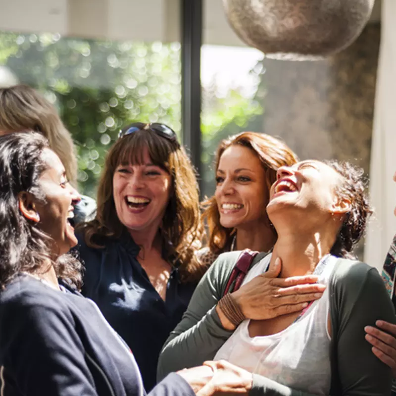 A group of women laugh together.