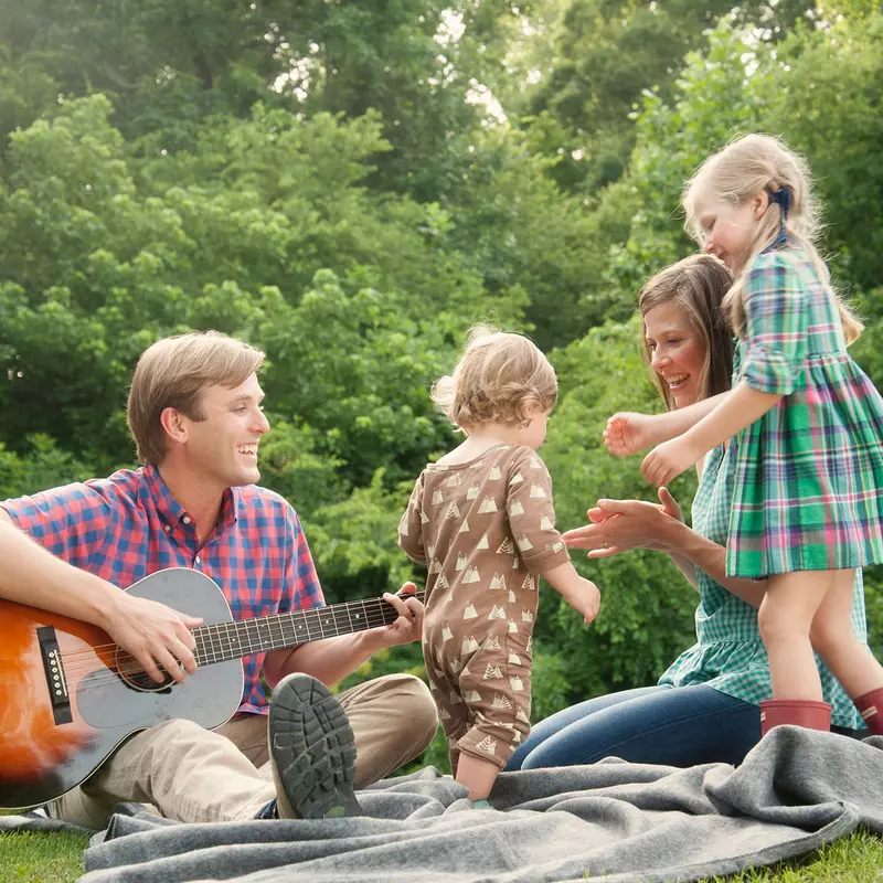 A dad's musical day in the park with his family.