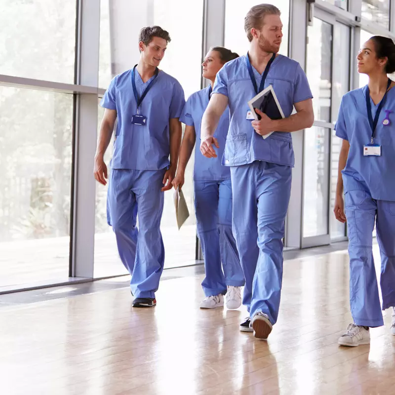 Group of nurses walking in the hall.