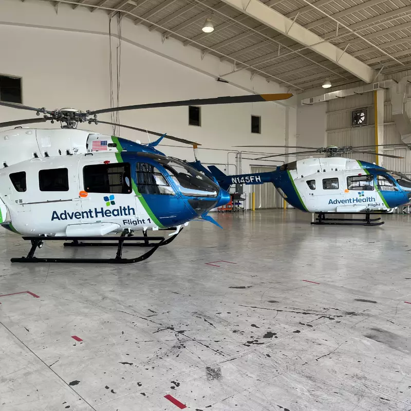 AdventHealth's two rescue helicopters at the hospital system's new hangar at the Orlando Executive Airport.