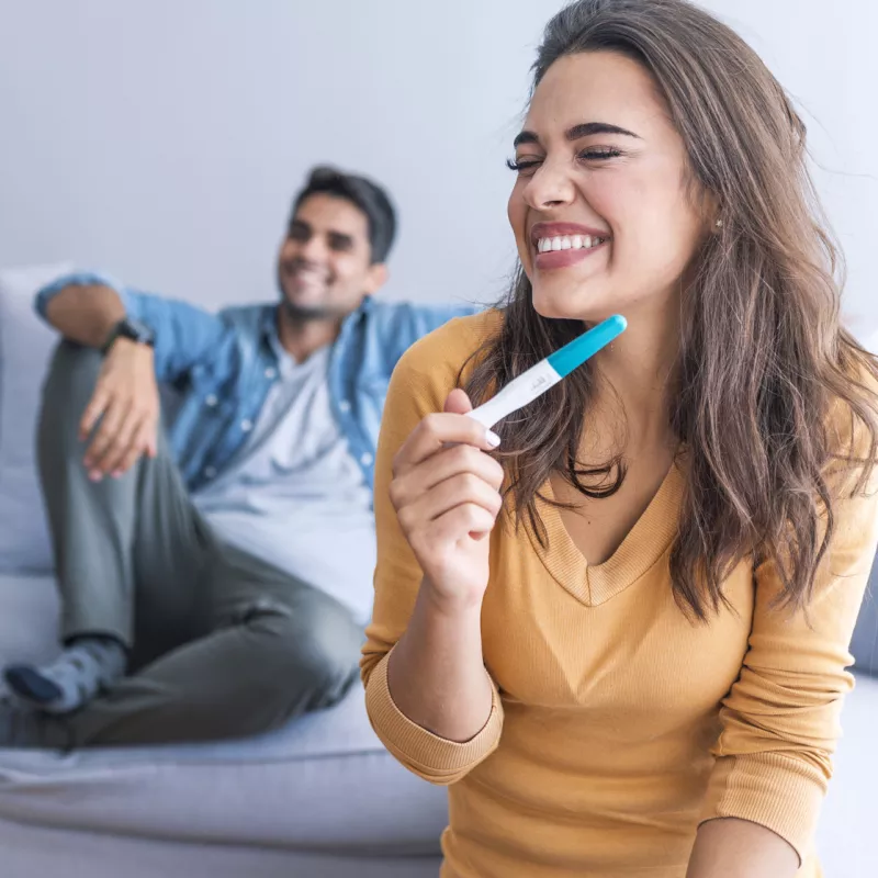 Overjoyed woman reading pregnancy test