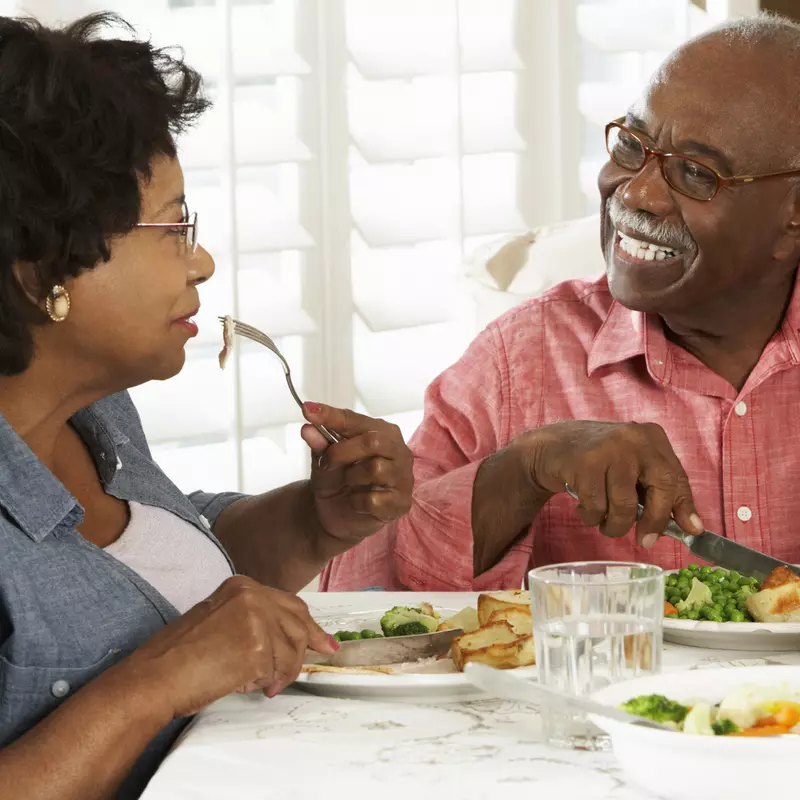 This caregiver eats a diabetic-friendly meal with their loved one.