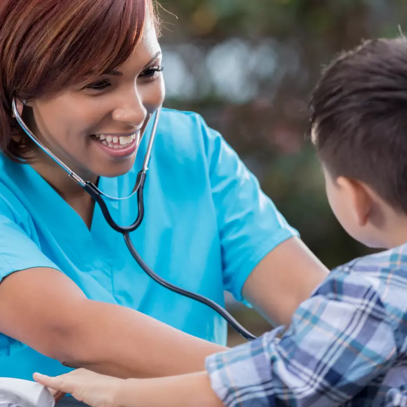 Nurse Listening to Boy's Heartbeat