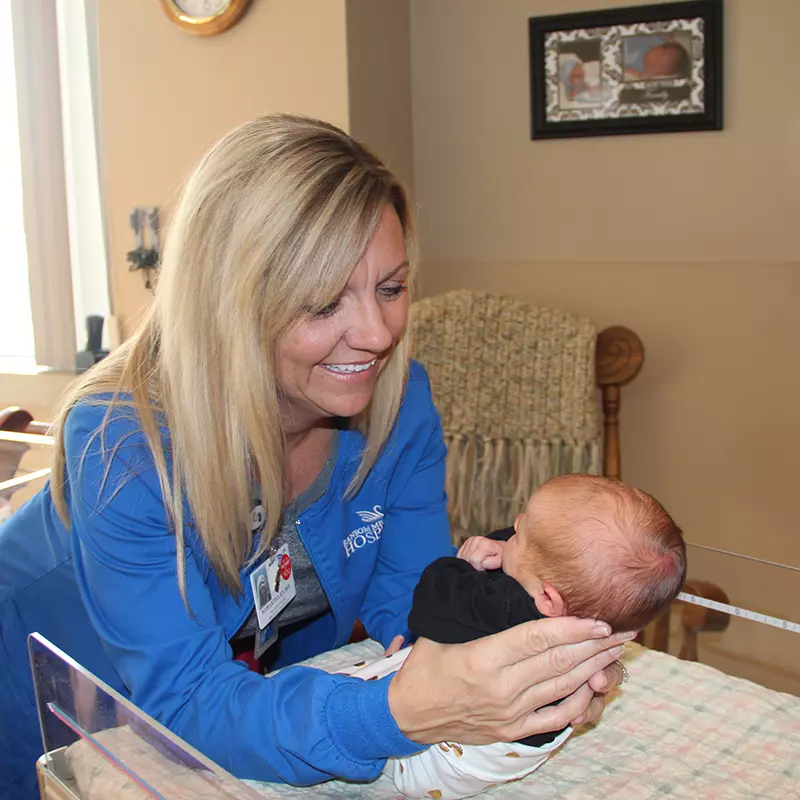 AdventHealth employee holding a baby