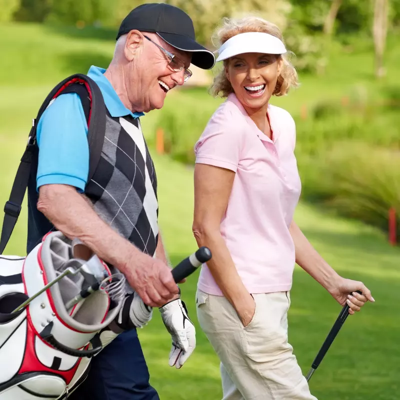A couple enjoys a golf game together.