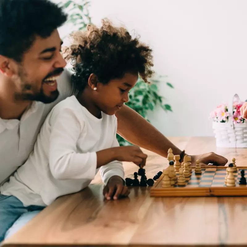 A family keeps their brains active by playing chess.
