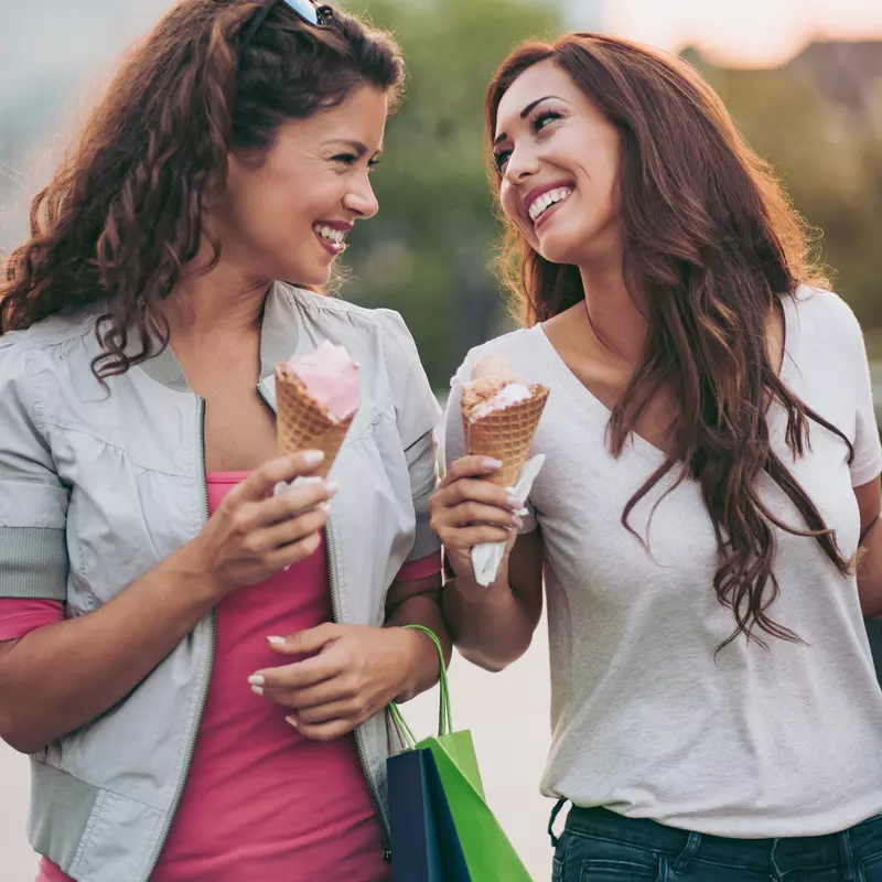 Two women enjoying ice cream.
