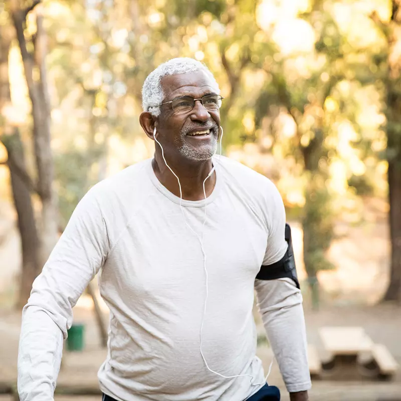 Older man excising outside