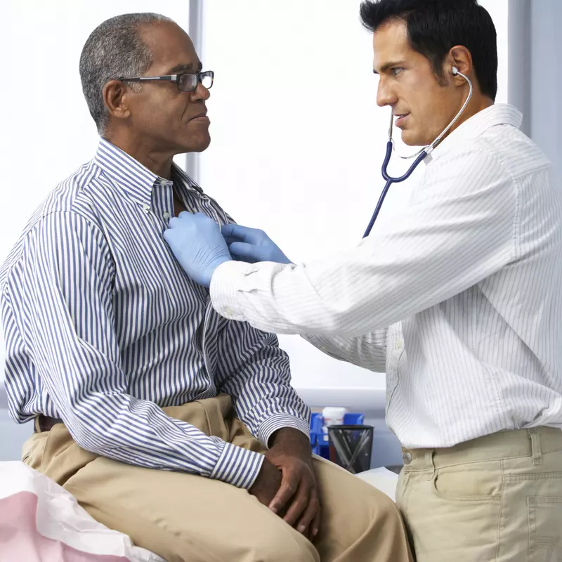 A doctor uses a stethoscope to listen to a patient's healthy heart.