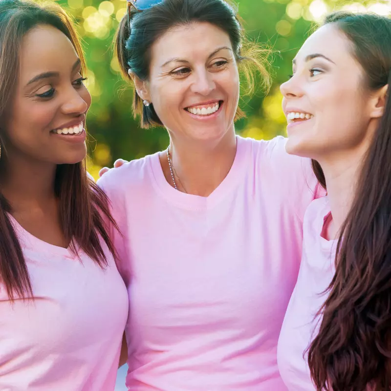 Three women in pink shirts