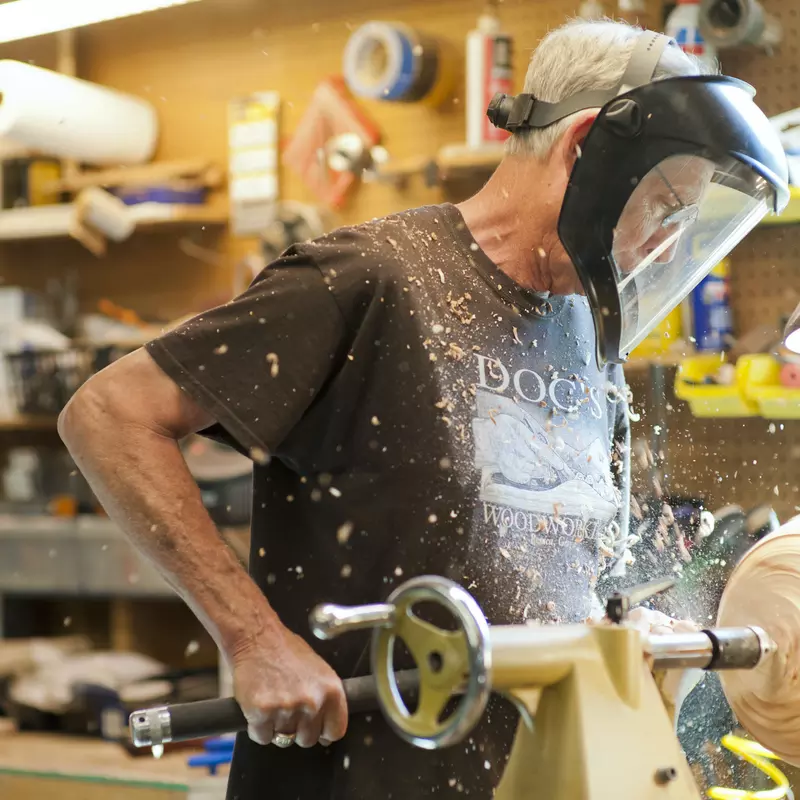 Mike Davis using a lathe to turn wood.