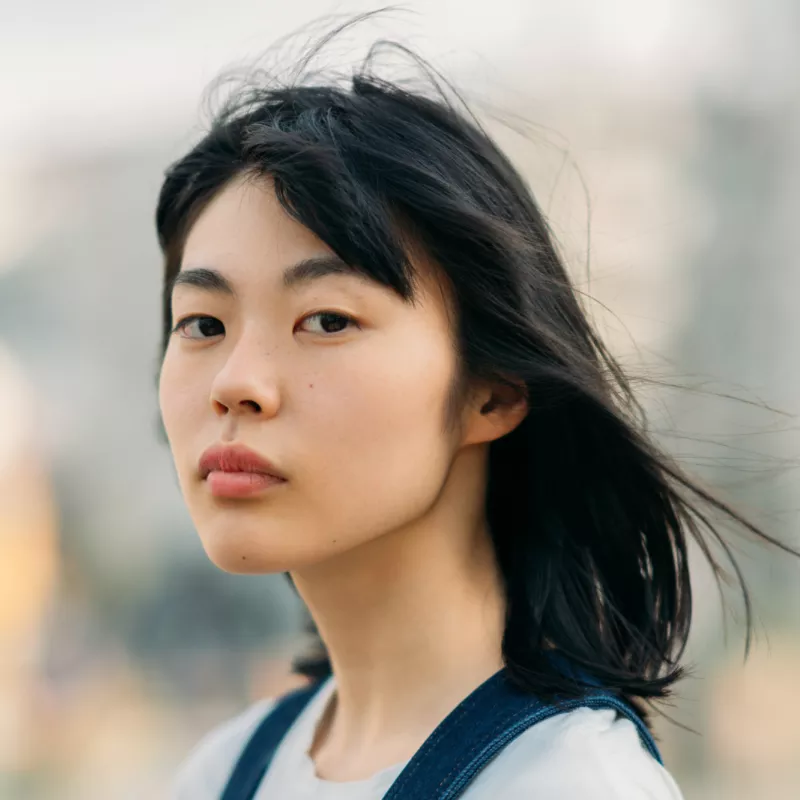 A Woman Looks Both Ways Before Crossing the Street