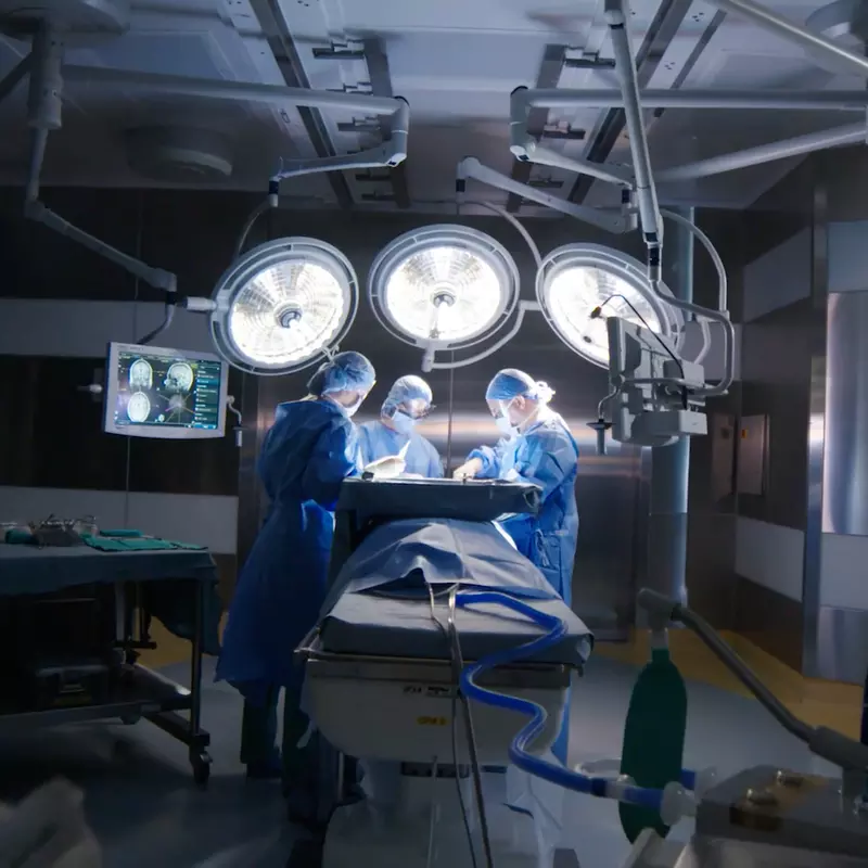 Three Doctors Work on a Patient in an Operating Room