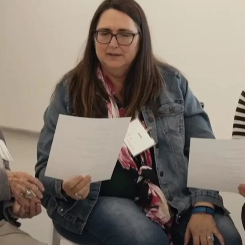 women seating while looking at papers