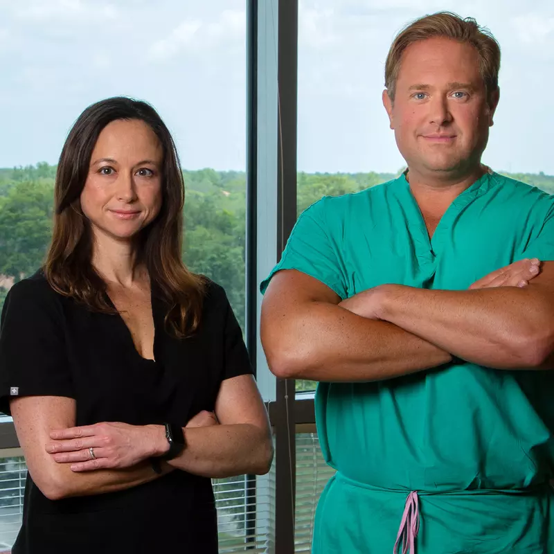 Doctor Allen Chudzinski and Doctor Haane Massarotti standing together in front of a window.