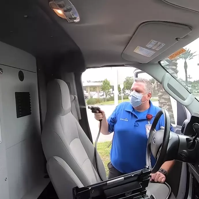 Team member decontaminates an ambulance using Aeroclave